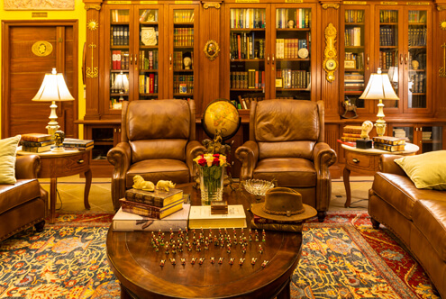 Opulent private library sitting area Opulent private library sitting area adorned with antiques, a luxurious touch for your luxury wedding venue.